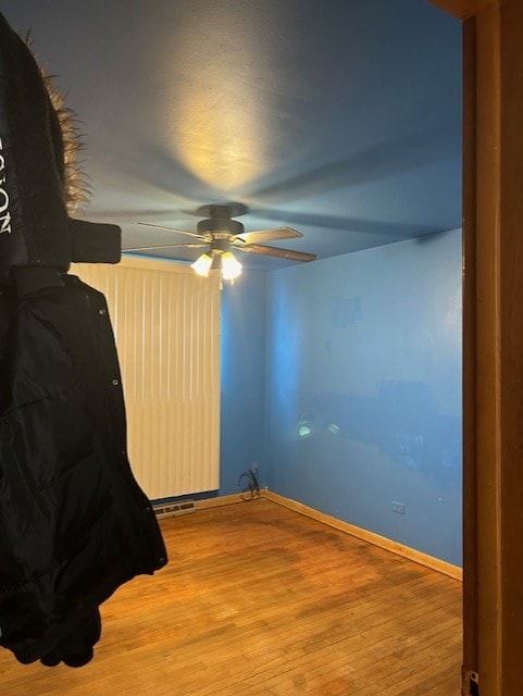 bedroom with ceiling fan and hardwood / wood-style flooring