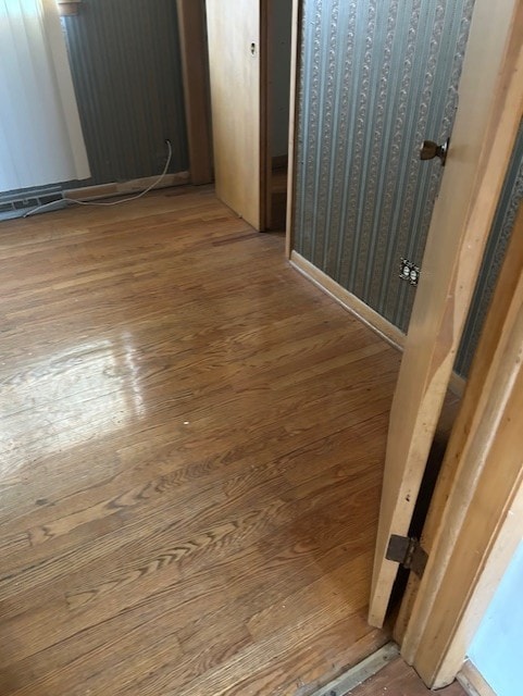 hallway with hardwood / wood-style flooring