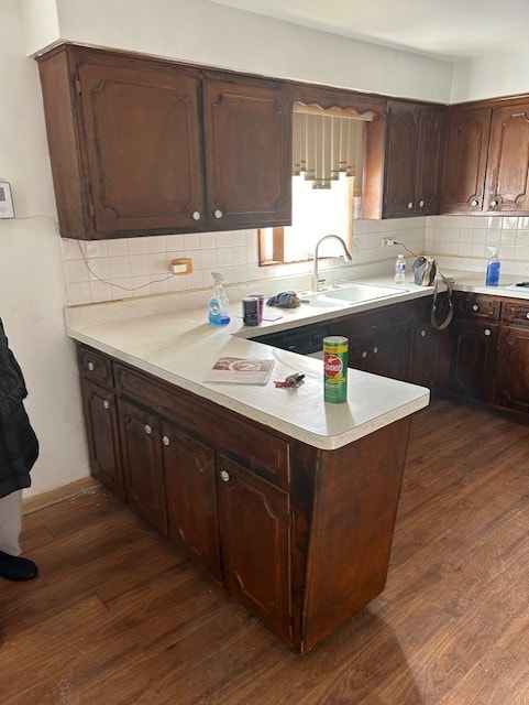 kitchen with decorative backsplash, dark hardwood / wood-style floors, and sink