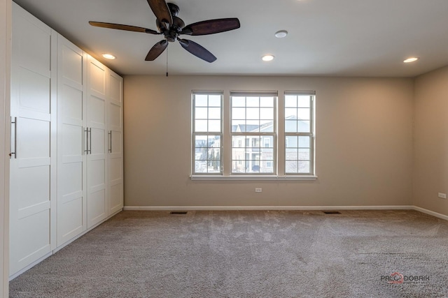 unfurnished bedroom featuring a closet, ceiling fan, and light colored carpet