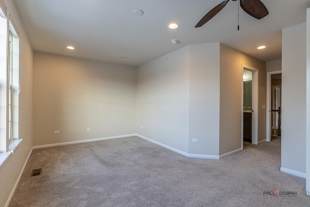 unfurnished room featuring ceiling fan and light colored carpet