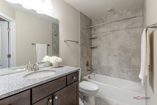 full bathroom featuring vanity, tile patterned floors, tiled shower / bath combo, and toilet