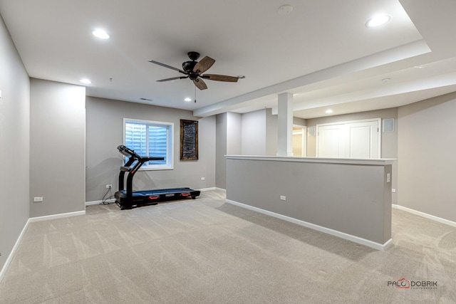 exercise room featuring ceiling fan and light carpet