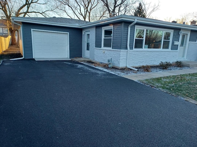 single story home with a garage