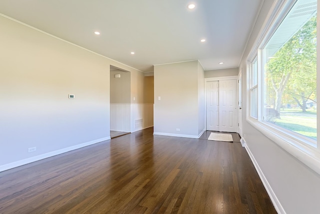 unfurnished room with crown molding and dark hardwood / wood-style flooring