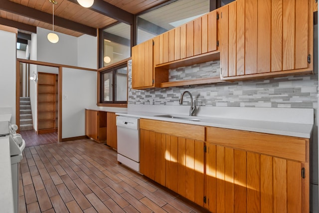 kitchen featuring pendant lighting, sink, decorative backsplash, light hardwood / wood-style floors, and white appliances