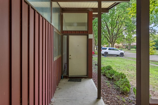 entrance to property with a lawn