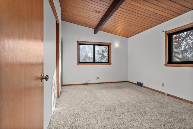 carpeted spare room with wood ceiling and vaulted ceiling with beams