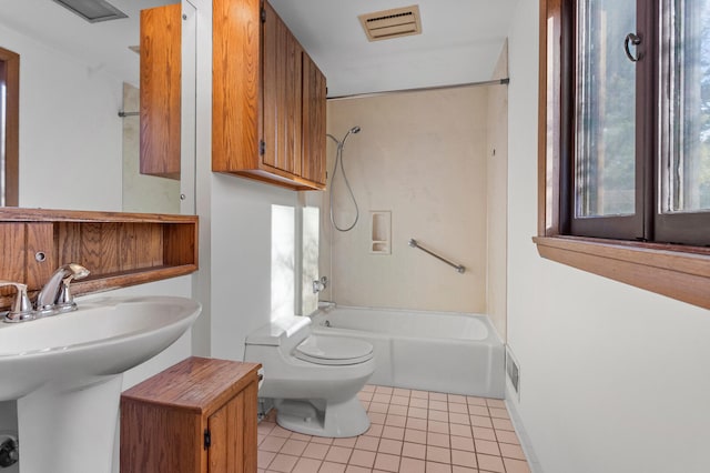 full bathroom featuring tile patterned floors, toilet, bathing tub / shower combination, and sink