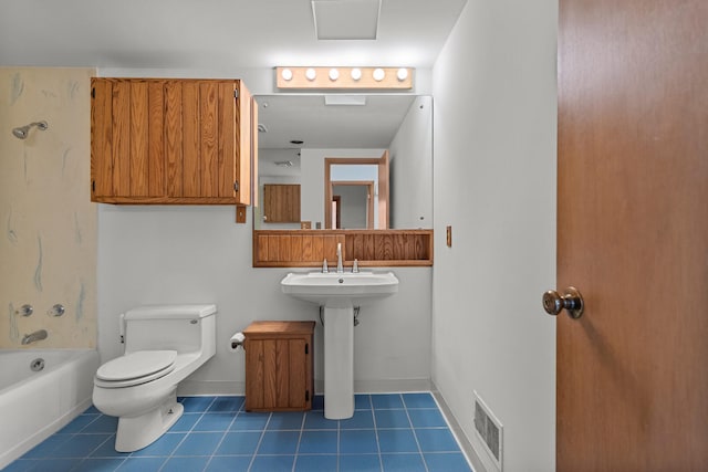 bathroom with tile patterned flooring, bathtub / shower combination, and toilet