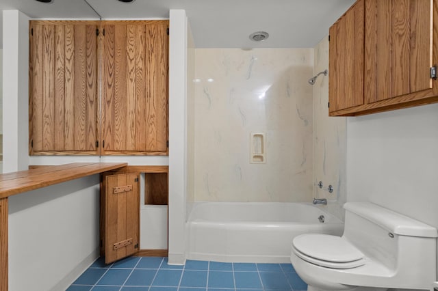 bathroom with tile patterned flooring, washtub / shower combination, and toilet