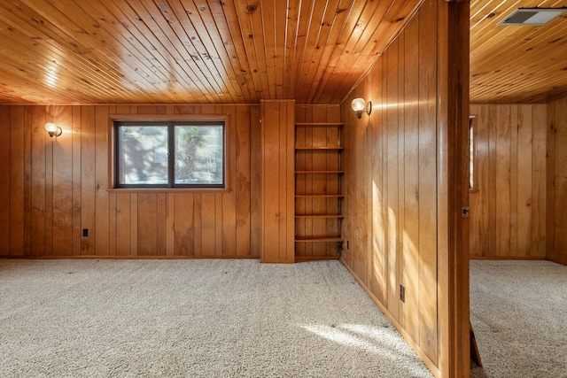 bonus room with wood ceiling, built in shelves, carpet, and wood walls