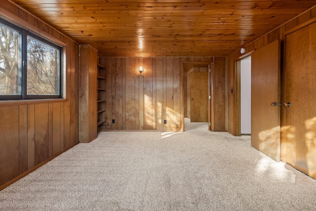 interior space featuring wood ceiling and wooden walls