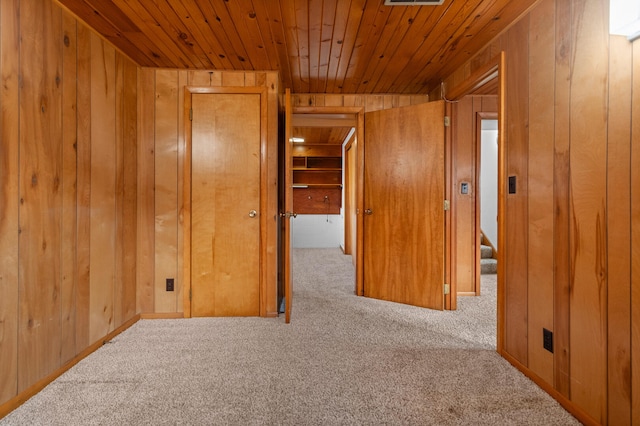 interior space with wooden ceiling and wood walls