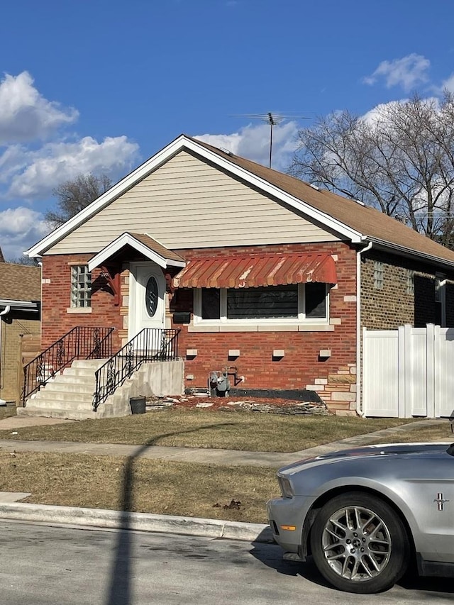 single story home featuring fence and brick siding