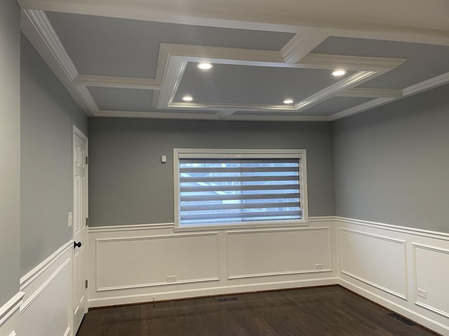 unfurnished room with dark wood-style floors, wainscoting, coffered ceiling, and visible vents