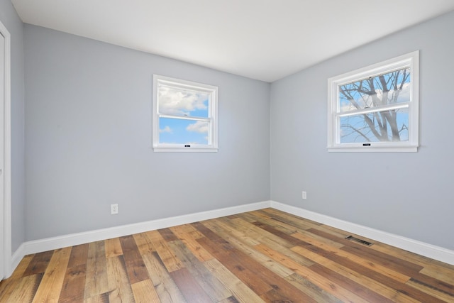 spare room with hardwood / wood-style floors