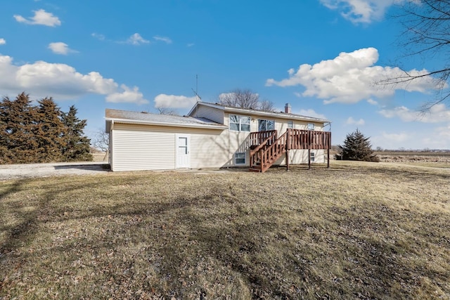 back of house with a wooden deck and a yard