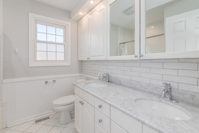 bathroom featuring tile patterned floors, toilet, vanity, and a shower with shower curtain