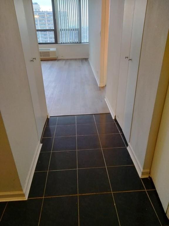 corridor with dark tile patterned floors