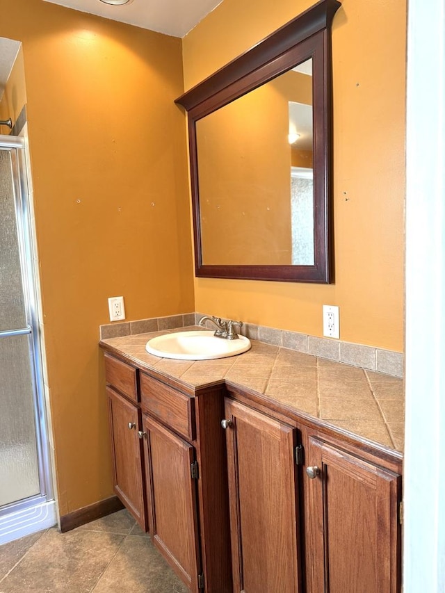 bathroom with vanity, tile patterned flooring, and a shower with door