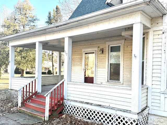 view of exterior entry featuring covered porch