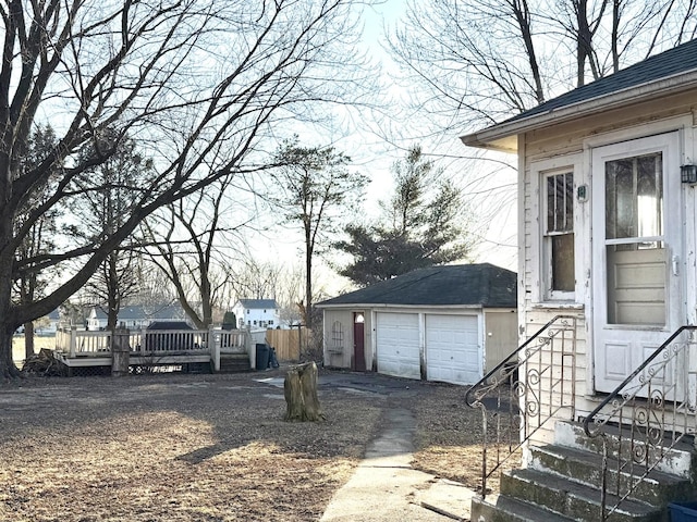 view of yard with a garage and an outbuilding