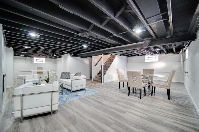 basement featuring wood-type flooring and plenty of natural light