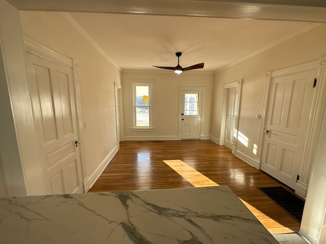 entryway with hardwood / wood-style flooring, crown molding, and ceiling fan