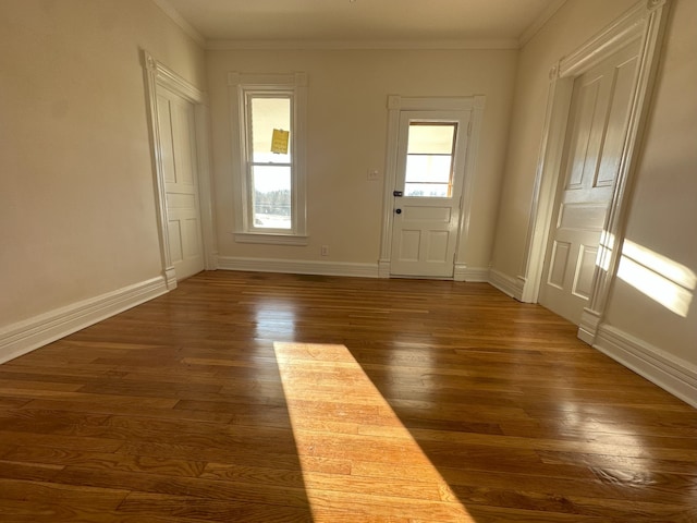 doorway to outside with dark hardwood / wood-style floors and crown molding