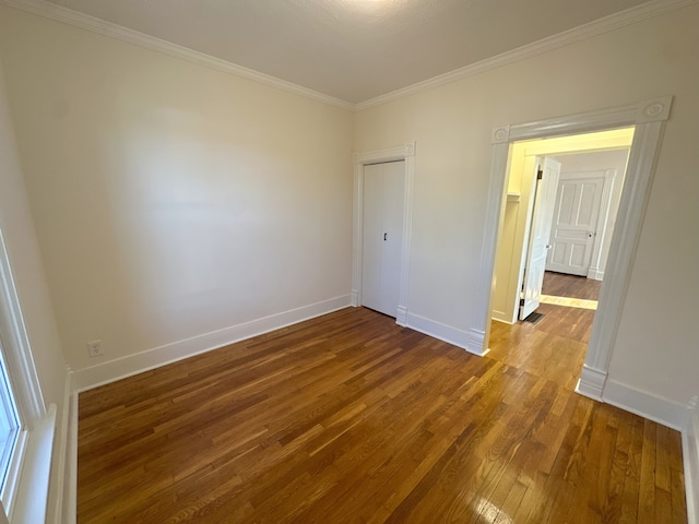 unfurnished bedroom with crown molding and wood-type flooring