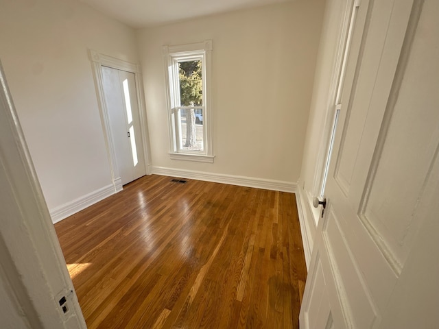 empty room with dark hardwood / wood-style floors