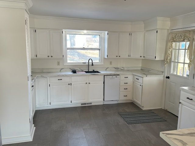 kitchen with white cabinets, light stone counters, white dishwasher, and sink