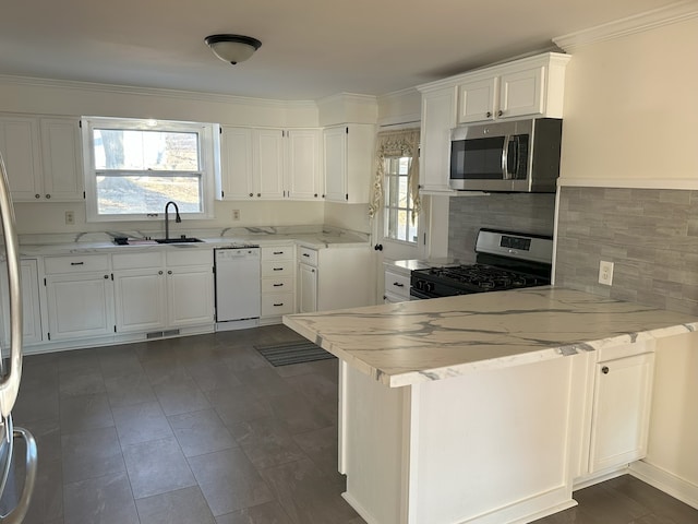 kitchen featuring dishwasher, white cabinetry, gas range oven, sink, and kitchen peninsula