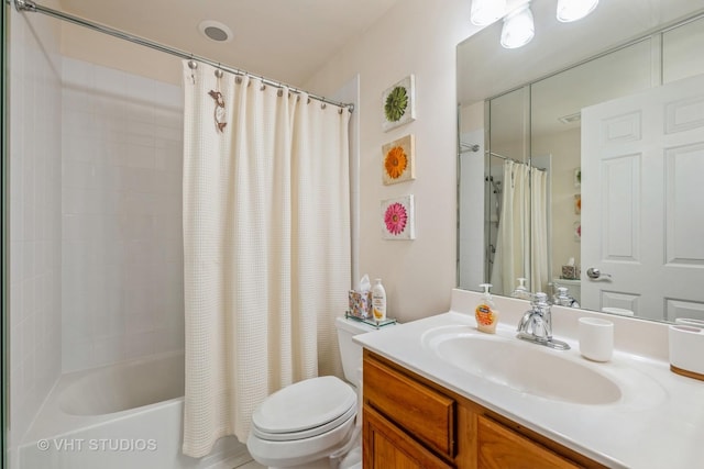 full bathroom featuring vanity, shower / bath combo, and toilet