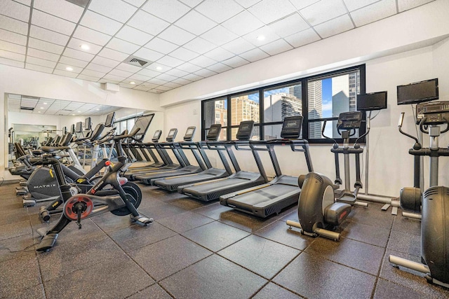 gym with a paneled ceiling