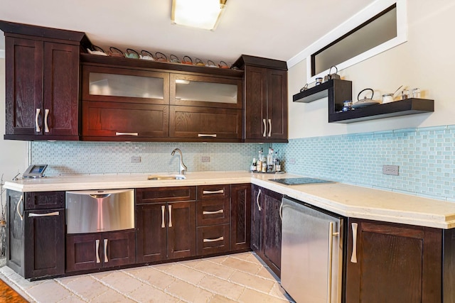 kitchen with refrigerator, decorative backsplash, sink, dark brown cabinetry, and black electric cooktop