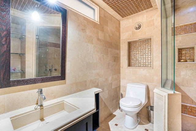 bathroom with toilet, a shower, tile walls, and vanity