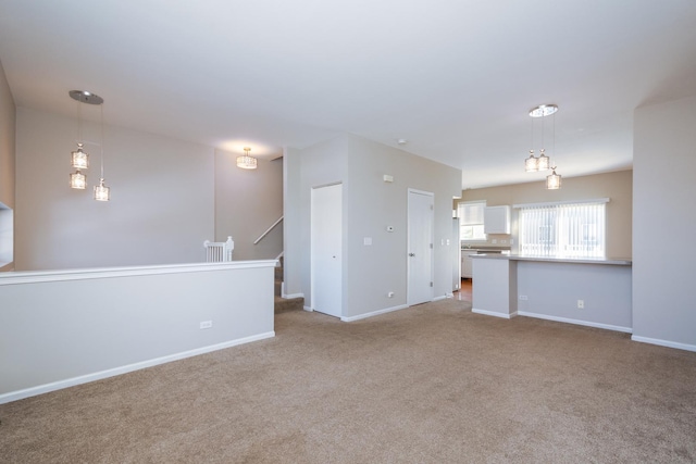 unfurnished living room featuring light colored carpet