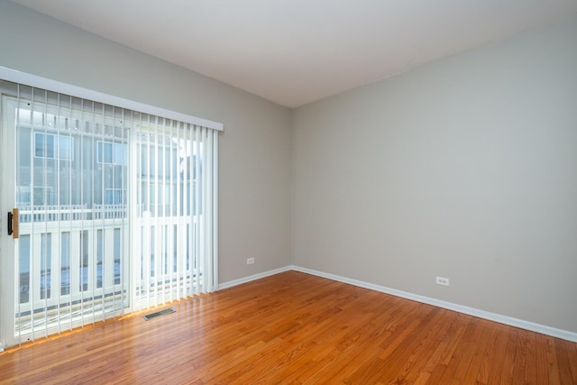 spare room with hardwood / wood-style floors