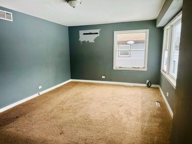 22012 Millard Ave, Richton Park, IL 60471 - spare room with a healthy amount of sunlight, arched walkways, carpet, and visible vents