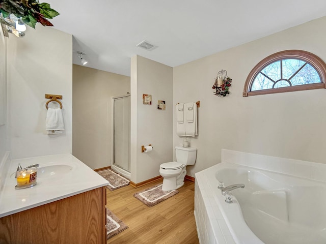 full bathroom featuring wood-type flooring, toilet, vanity, and plus walk in shower