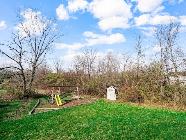 view of yard with a playground and a storage unit