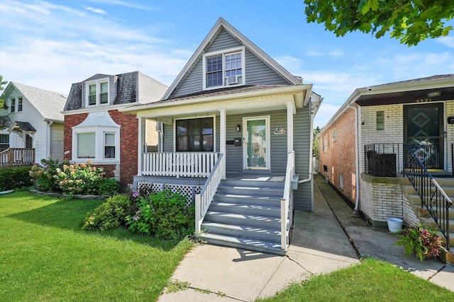 bungalow-style house featuring covered porch and a front yard