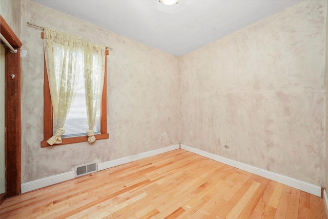 empty room featuring hardwood / wood-style flooring