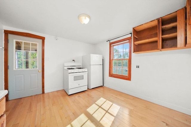 kitchen with white appliances and light hardwood / wood-style flooring