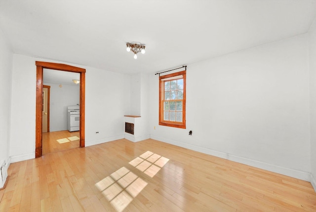 spare room with light wood-type flooring