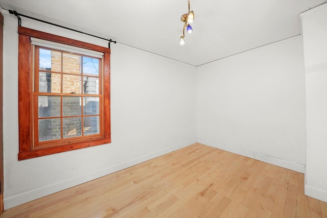 empty room with hardwood / wood-style flooring