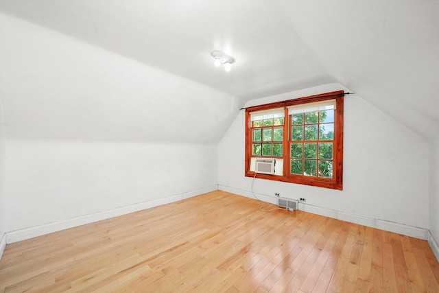 bonus room featuring wood-type flooring, vaulted ceiling, and cooling unit