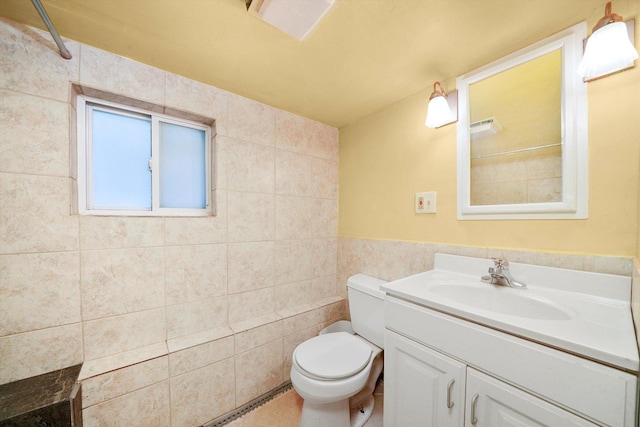 bathroom with tile walls, toilet, and vanity